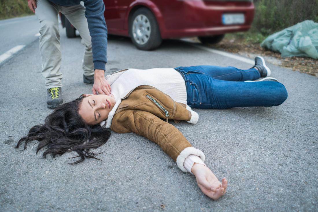 Man Checking On Unconscious Woman