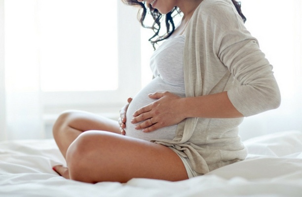 Pregnant Woman Touching Her Stomach