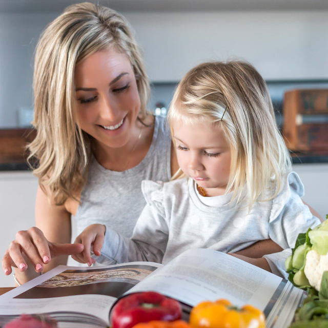 Shannon And Grace Reading A Cookbook