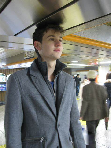 A Man Standing with his Head Brushing the Ceiling in the Metro