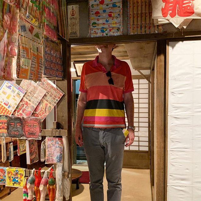 A Man Standing at a Shop Entrance