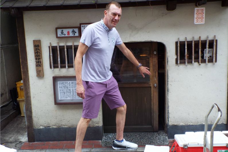 A Man Stands Next to a Doorway