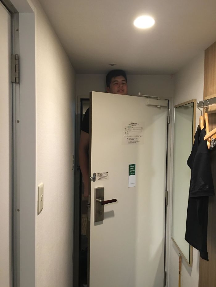 Man Standing Behind Hotel Door