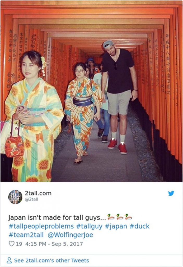 A Man Walks Through Torii Gates