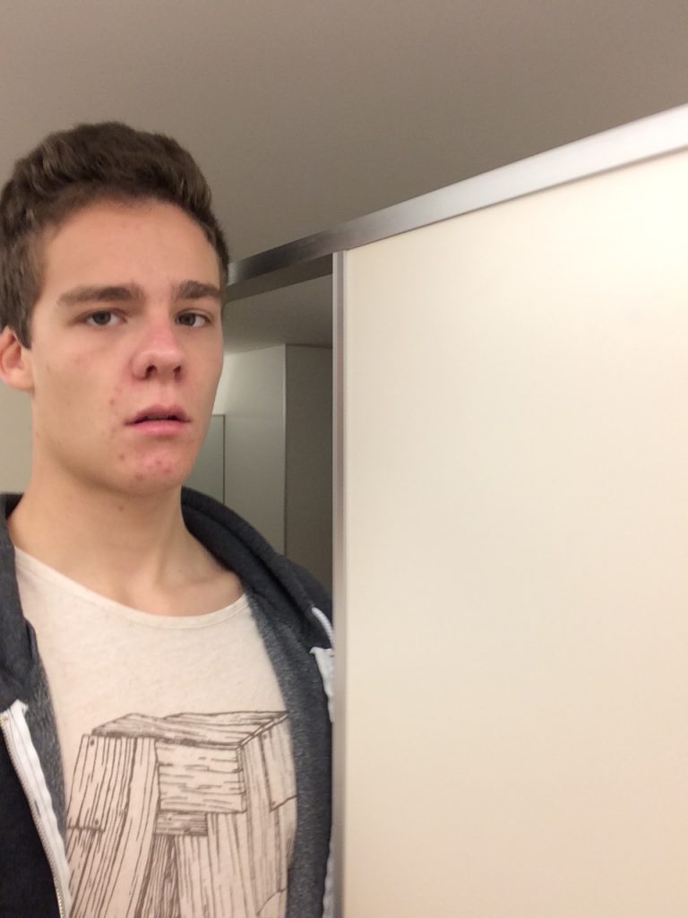 Man standing Next to Toilet Cubicles