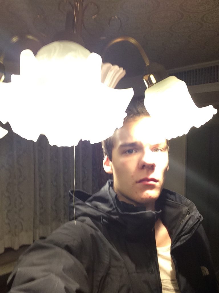 Man Stands with Head Near Lighting