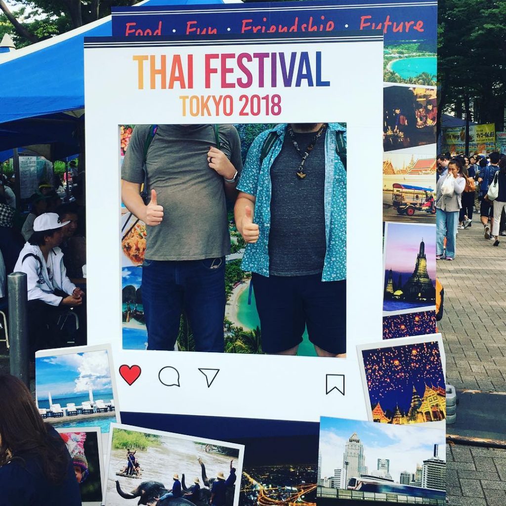 Two Men Stand by Picture Frame