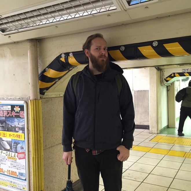 Man Stands Next to Metro Archway