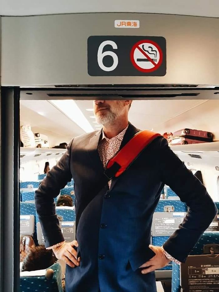 A Businessman Stands on one of Japan’s Trains