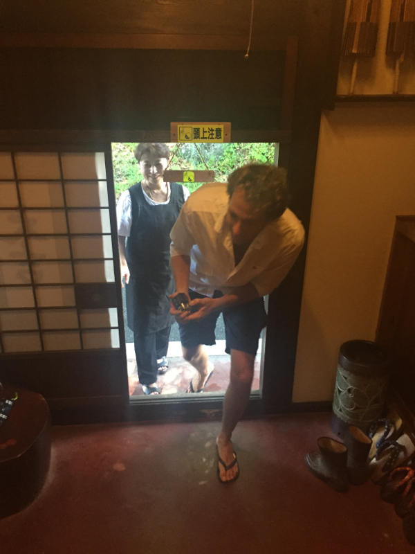 Man Enters into a Ryokan, a Traditional Japanese Inn
