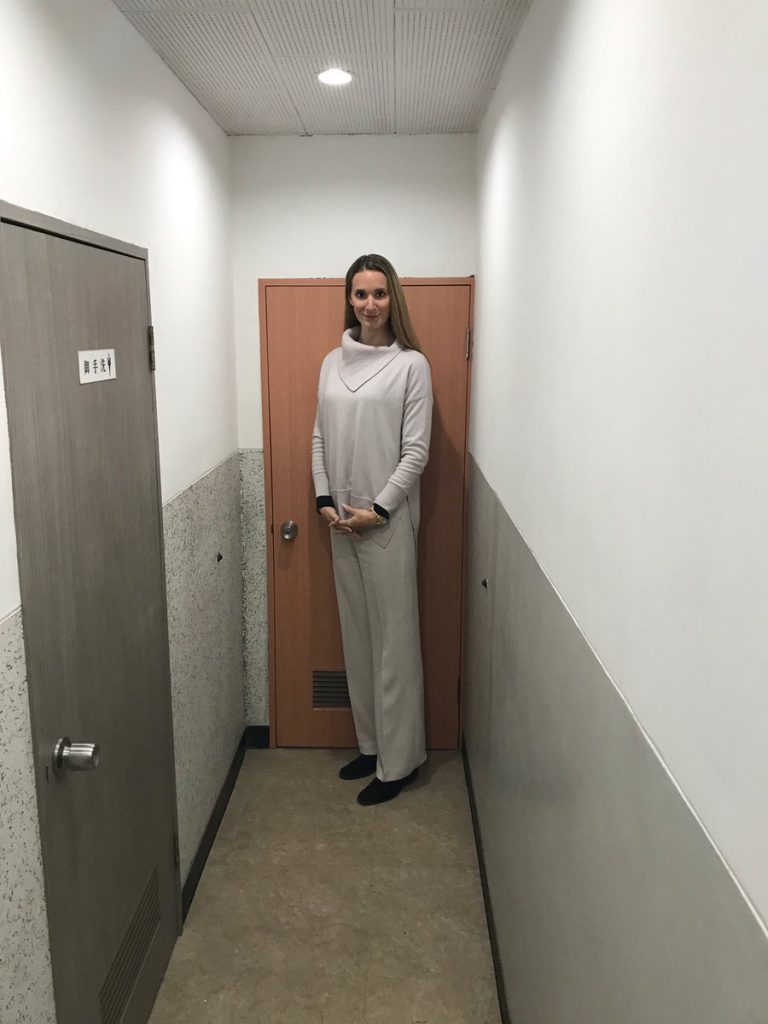 Tall Woman Standing Next to Door