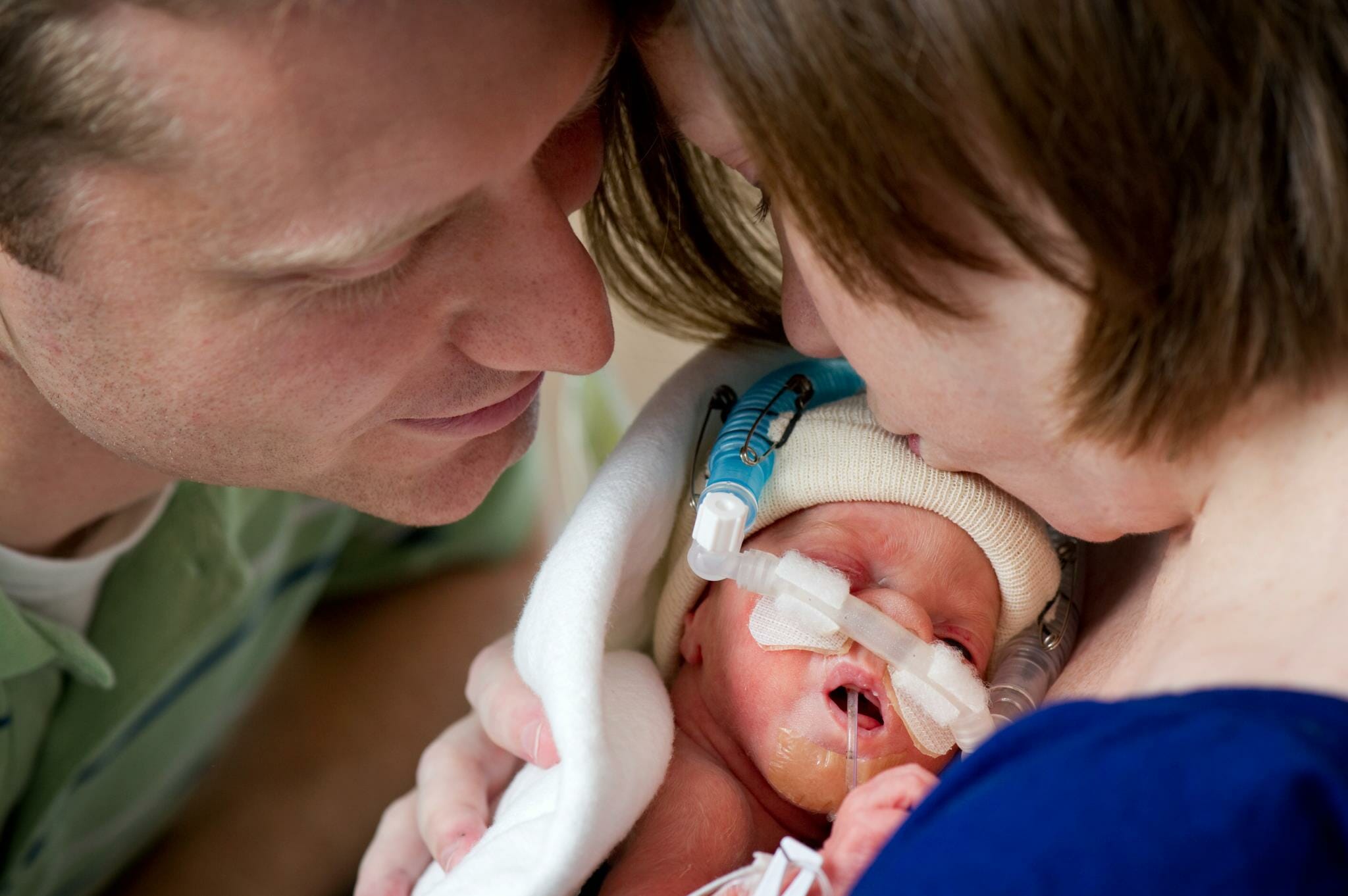 David And Lauren Perkins Holding One Of Their Newborns