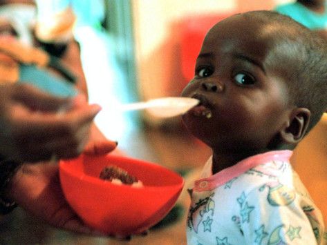 Young Boy Being Fed