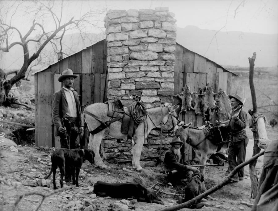 Trappers Outside Of Their Cabin