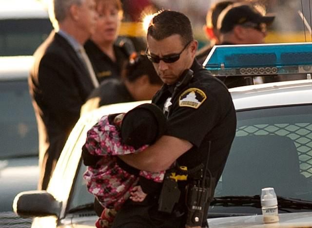 Officer Cradling Rescued Baby