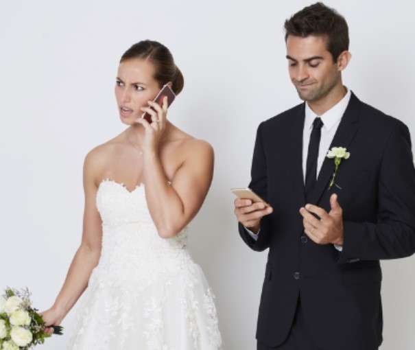 Bride And Groom Using Their Phones