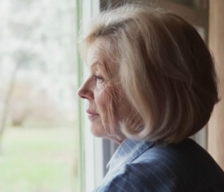 Old Woman Looking Out Window